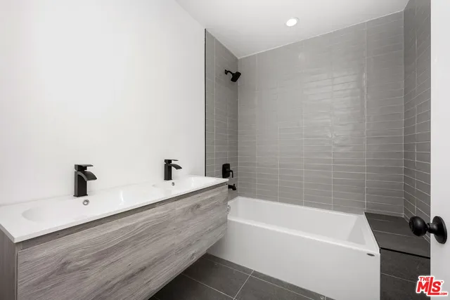 a bathroom with a bathtub and a sink