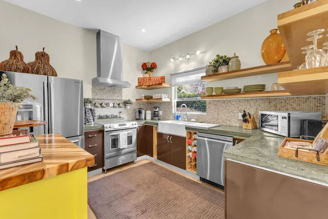 a kitchen with a sink a stove and cabinets