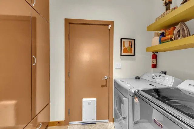 a bedroom with a bed and dresser with window