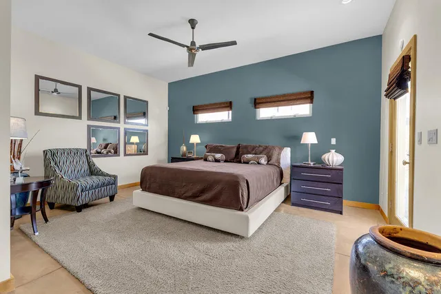 a bedroom with a bed and a painting on the wall