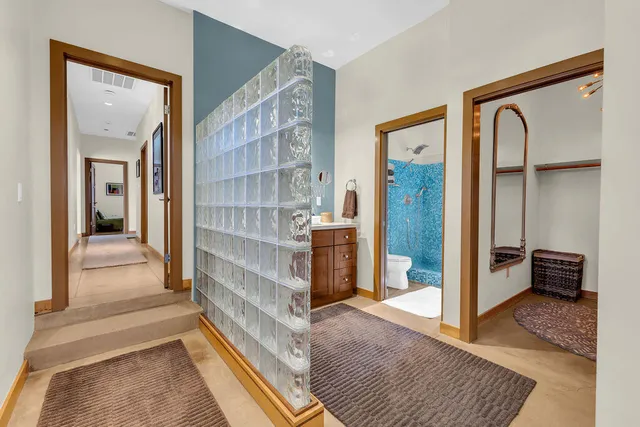 a bathroom with a sink vanity mirror and toilet