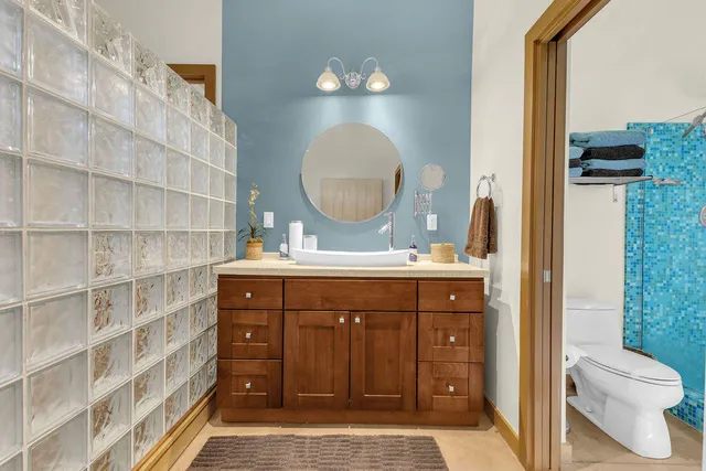 a bathroom with a glass shower door