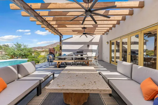 a view of a house with a backyard porch and sitting area