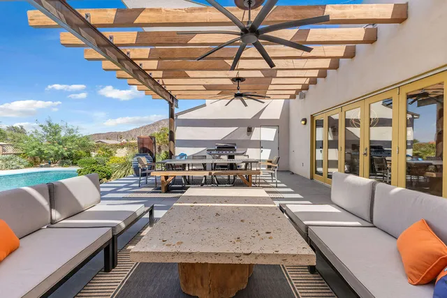 a view of a house with a backyard porch and sitting area