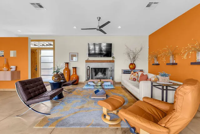 a living room with fireplace furniture and a flat screen tv