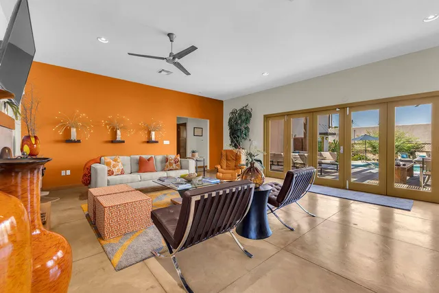 a living room with furniture a large window and a fireplace