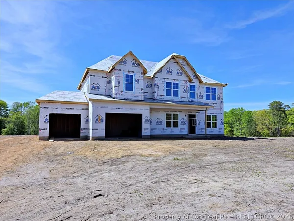 a front view of house with yard and garage