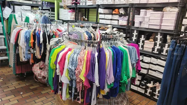 a view of walk in closet with clothes