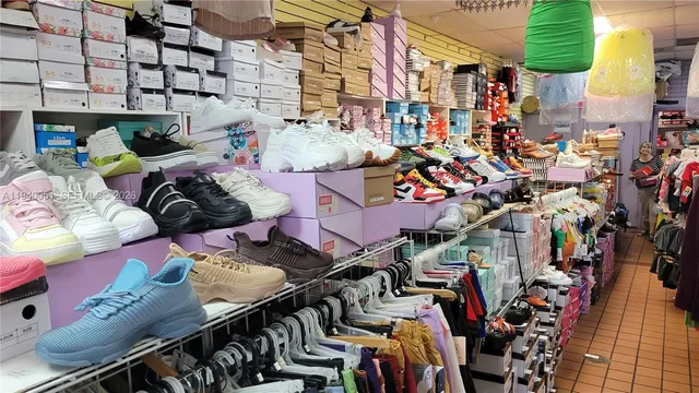 a view of walk in closet with clothes