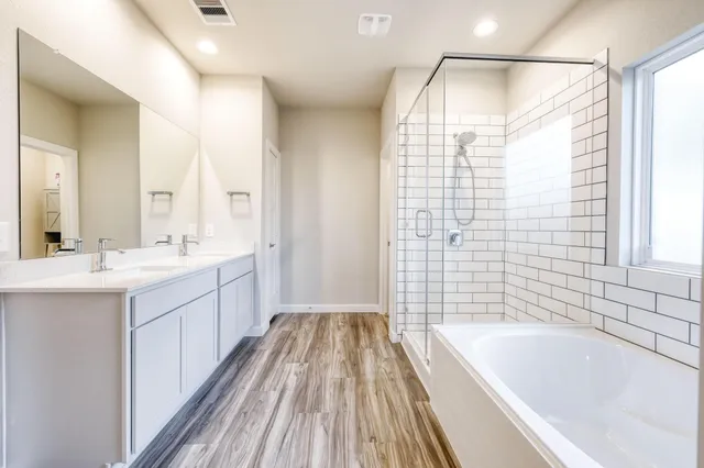 a bathroom with a double vanity sink and a bathtub