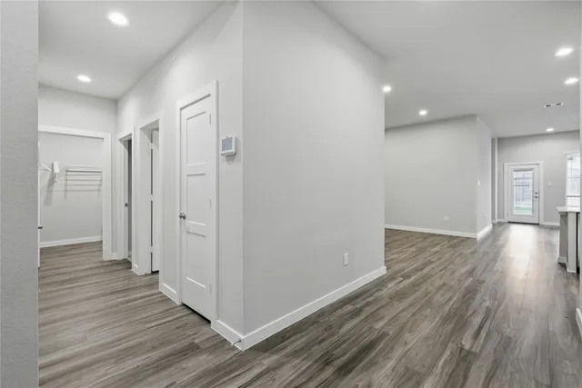 a view of a hallway with wooden floor