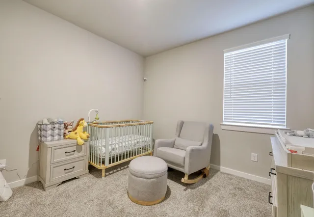 a bedroom with furniture and a window