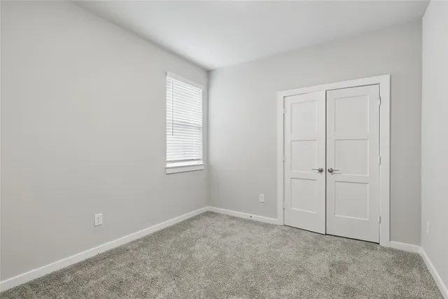 a view of an empty room with closet area