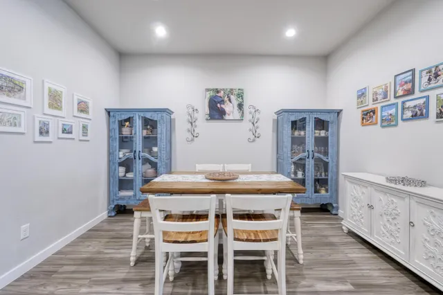 a dining room with furniture and wooden floor