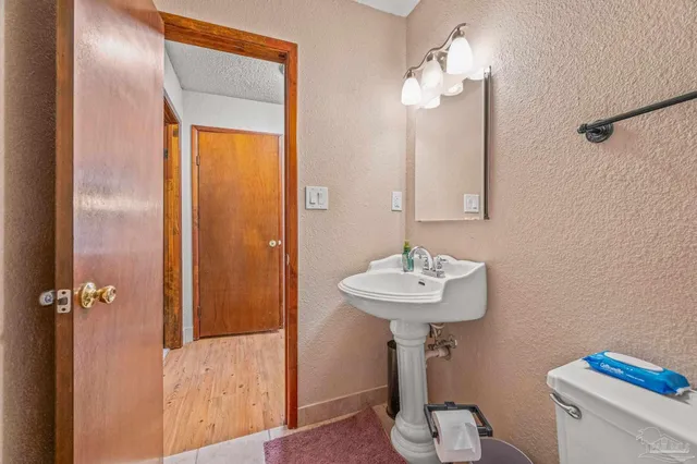 a bathroom with a sink a mirror and a toilet