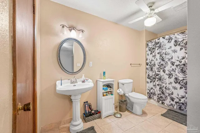 a bathroom with a sink toilet and a mirror