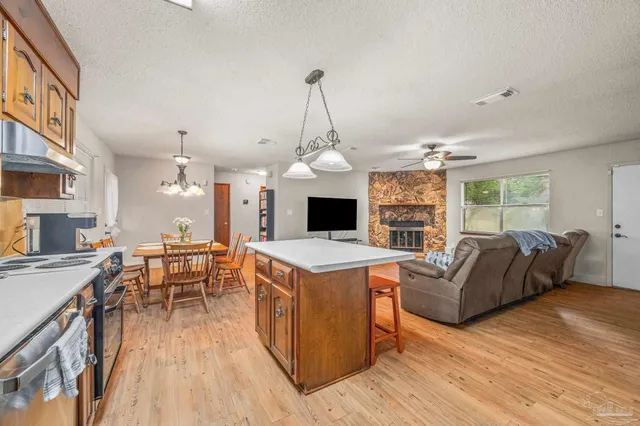 a living room with furniture a fireplace and a chandelier