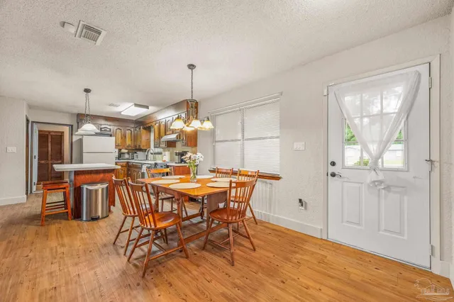 a view of a dining room with furniture and chandelier