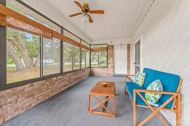 a bedroom with furniture and a large window