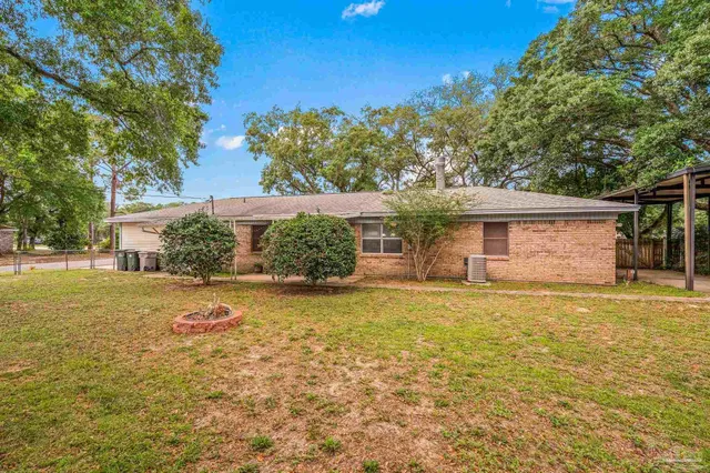 a front view of house with yard and trees