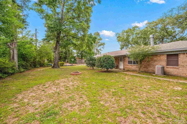a yellow house with trees in front of it