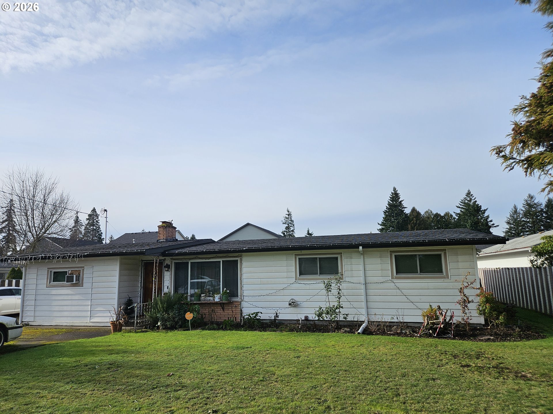 4747 Homer Road Northeast Salem, OR 97305 - Photo 1 of 21 a view of a yard in front of a house with plants and large tree