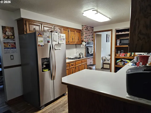 a kitchen with stainless steel appliances a refrigerator and a stove