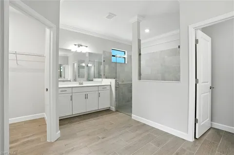 a spacious bathroom with a mirror sink and shower