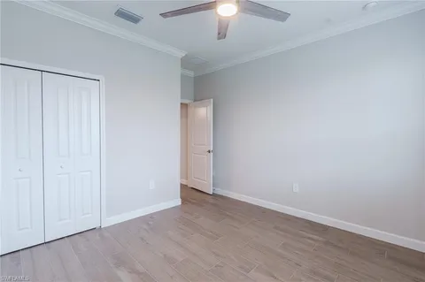 a kitchen with stainless steel appliances kitchen island granite countertop a table chairs and a refrigerator