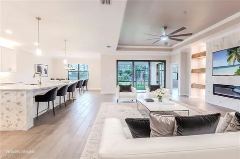 a kitchen with kitchen island a sink stainless steel appliances and white cabinets