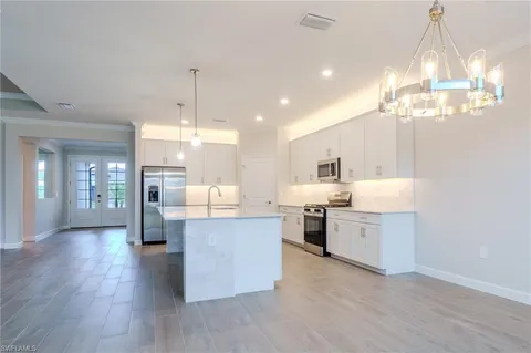 a living room with stainless steel appliances kitchen view and living room view