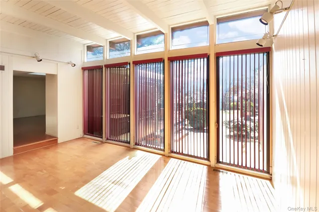 a view of a room with wooden floor and windows