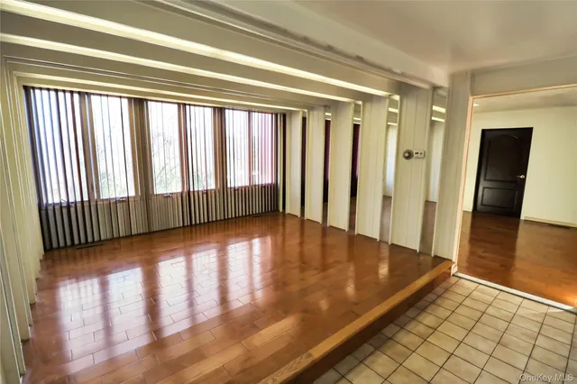 a view of a room with wooden floor