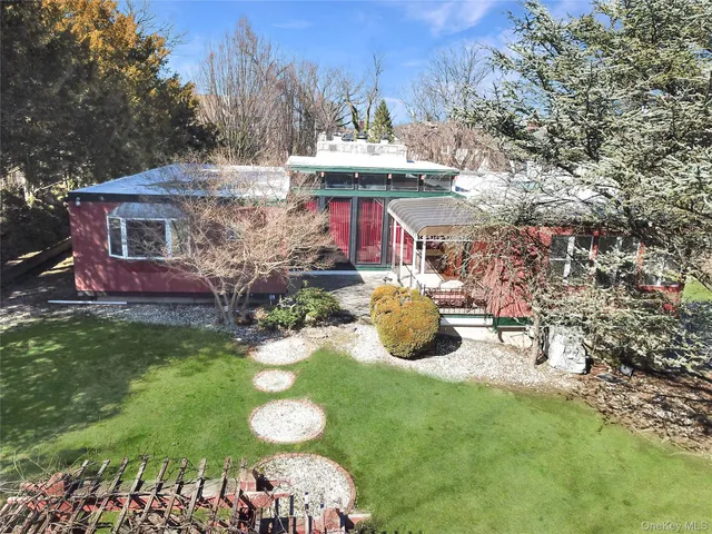 a view of a chairs and table in backyard of the house