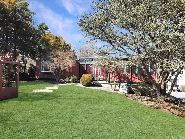 a view of a house with a backyard