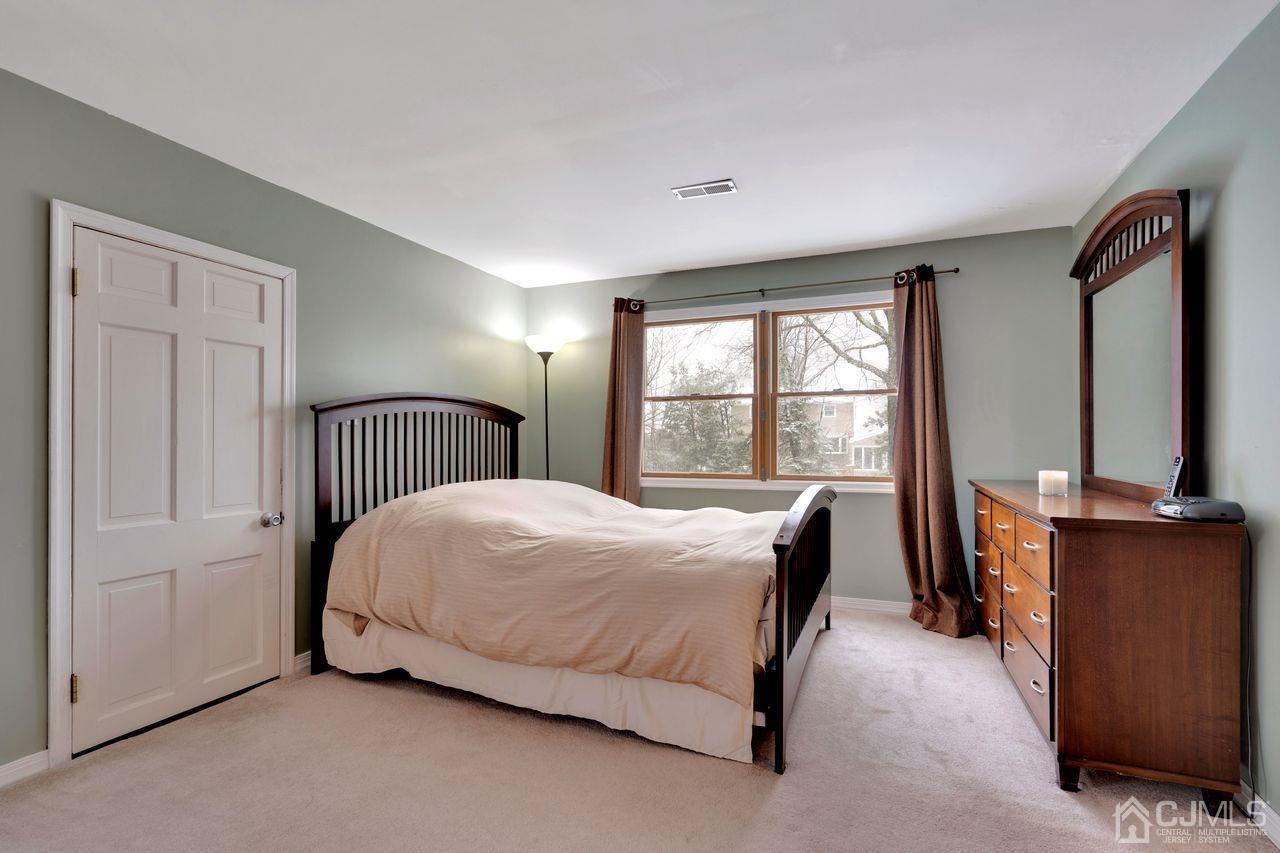 381 Plainfield Road Edison, NJ 08820 - Photo 14 of 23 a bed room with a bed and a window