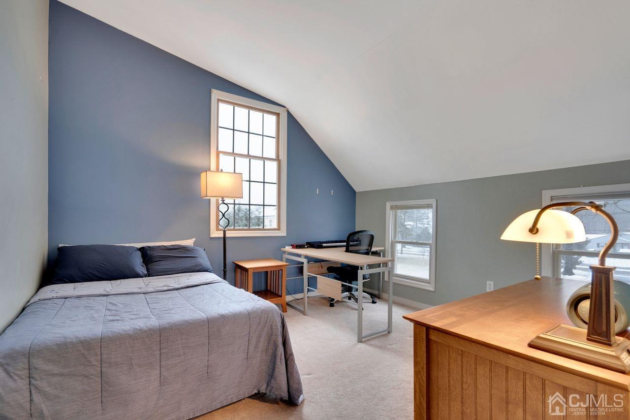 381 Plainfield Road Edison, NJ 08820 - Photo 18 of 23 a bedroom with a bed and a table