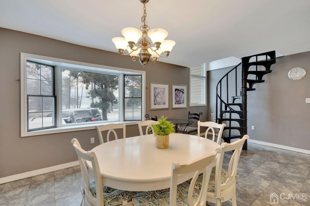 381 Plainfield Road Edison, NJ 08820 - Photo 6 of 23 a view of a dining room with furniture wooden floor and chandelier