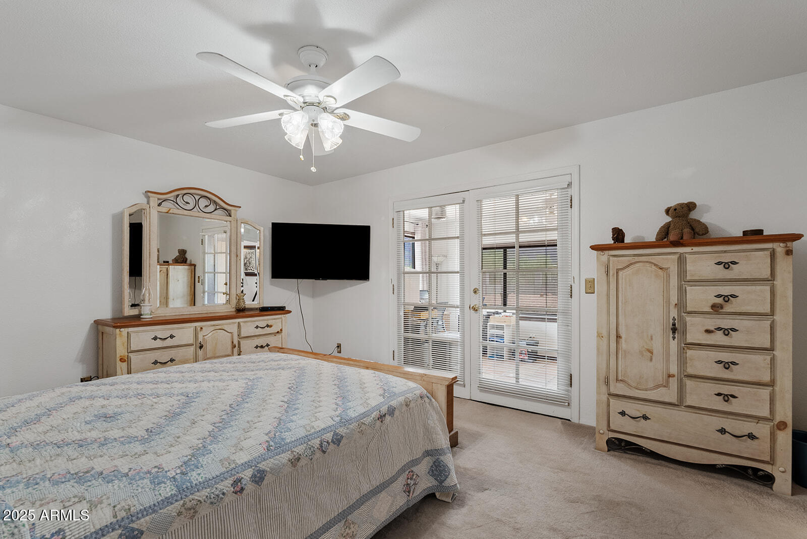 75 North Val Vista Road Apache Junction, AZ 85119 - Photo 18 of 39 a bedroom with a bed and a flat tv screen on dresser