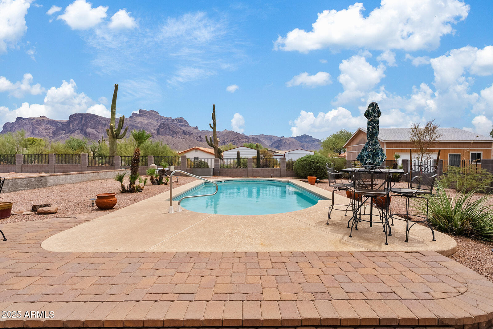 75 North Val Vista Road Apache Junction, AZ 85119 - Photo 27 of 39 a view of a swimming pool with a table and chairs