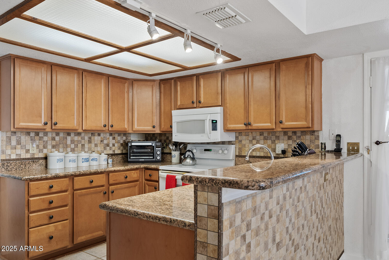 75 North Val Vista Road Apache Junction, AZ 85119 - Photo 8 of 39 a kitchen with granite countertop cabinets sink and stainless steel appliances