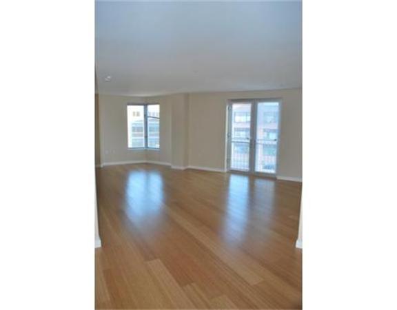 16 Miner Street, Unit 607 Boston, MA 02215 - Photo 4 of 10 a view of an empty room with wooden floor and a window