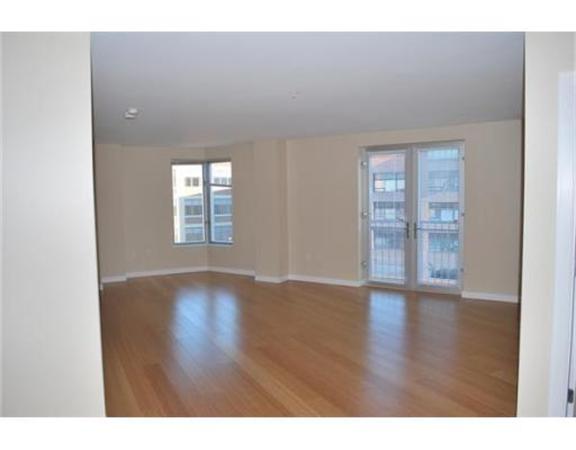 16 Miner Street, Unit 607 Boston, MA 02215 - Photo 5 of 10 a view of an empty room with wooden floor and a window