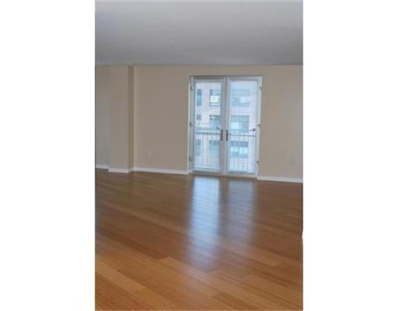 16 Miner Street, Unit 607 Boston, MA 02215 - Photo 6 of 10 a view of an empty room with wooden floor and a window