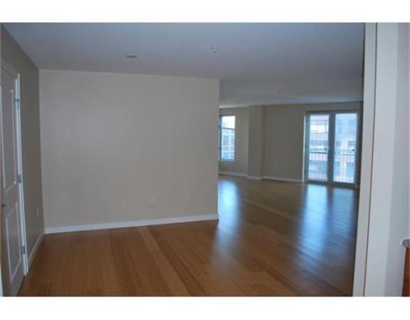 16 Miner Street, Unit 607 Boston, MA 02215 - Photo 8 of 10 a view of an empty room with wooden floor and a window