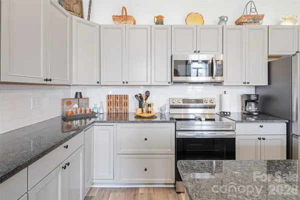 a kitchen with stainless steel appliances a sink stove and refrigerator