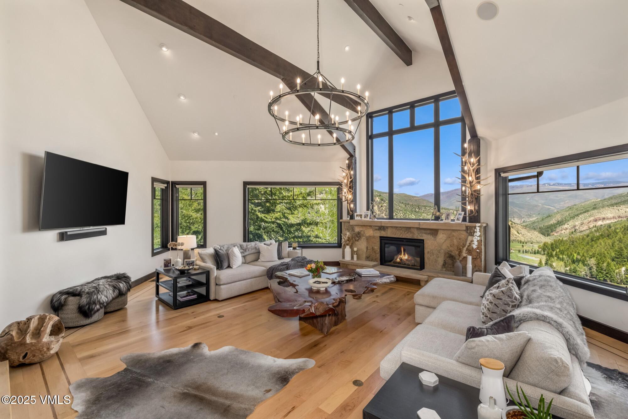 a living room with furniture a fireplace and a flat screen tv