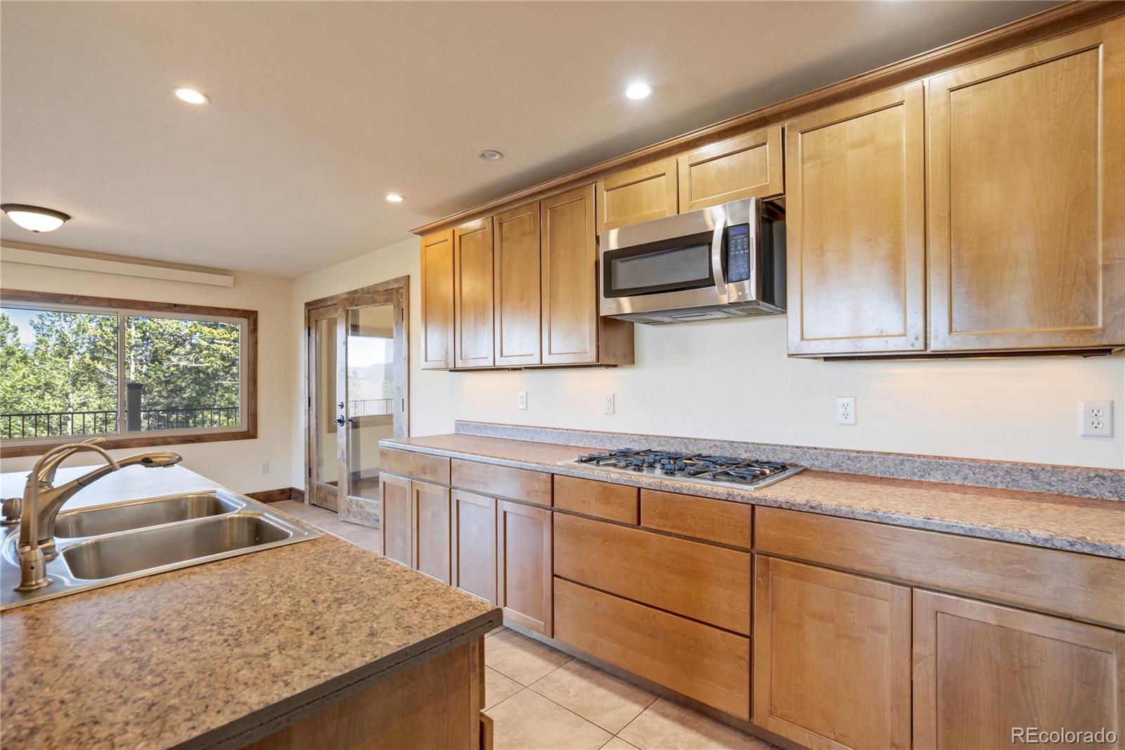 85 Santa Fe Mountain Road Evergreen, CO 80439 - Photo 15 of 47 a kitchen with stainless steel appliances granite countertop a sink stove and microwave