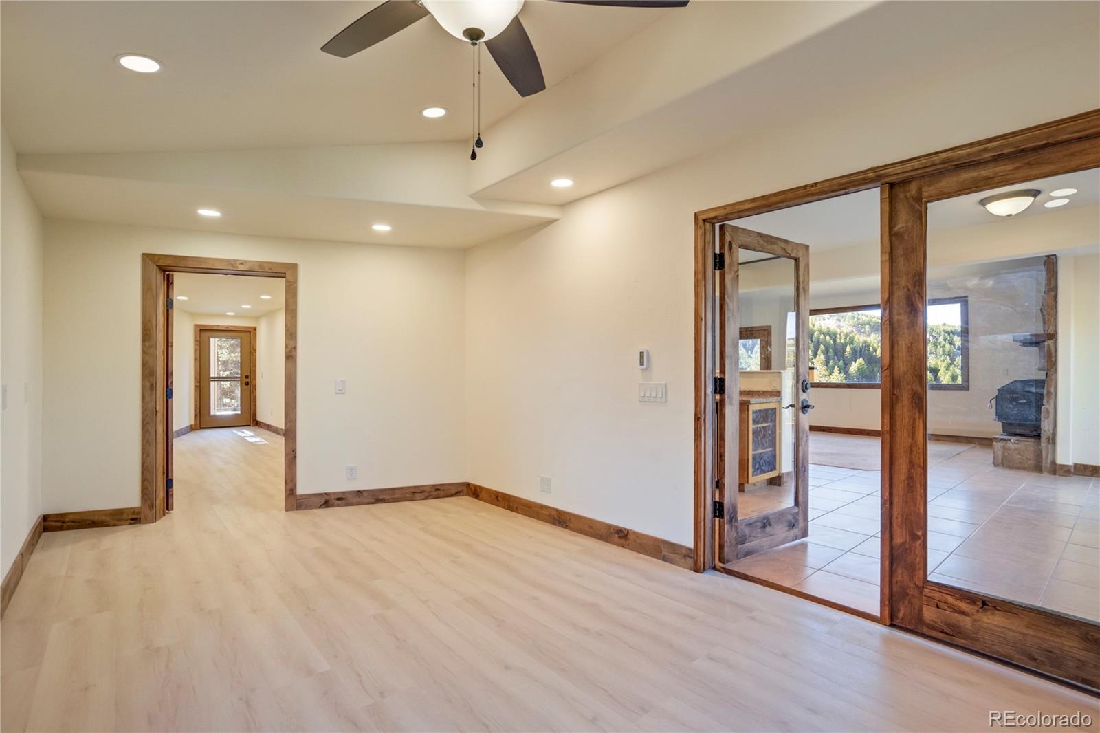 85 Santa Fe Mountain Road Evergreen, CO 80439 - Photo 19 of 47 wooden floor in an empty room with a window