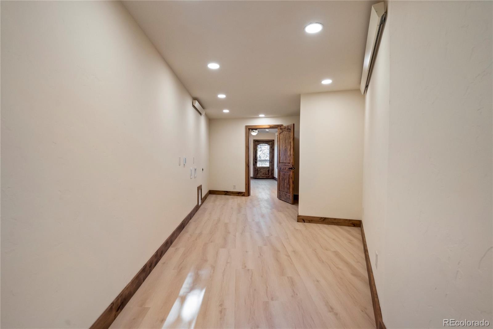 85 Santa Fe Mountain Road Evergreen, CO 80439 - Photo 20 of 47 a view of hallway with wooden floor